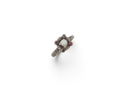 a close up of a ring on a white surface with a white background