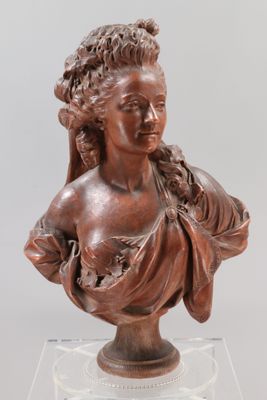 a bronze bust of a woman with a flowered head on a clear base