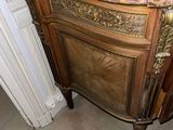 a marble top cabinet in the corner of a room