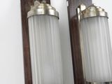 pair of wall sconces mounted on a white wall in a room