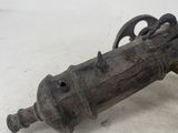 an old rusty gun with a wooden handle on a white surface