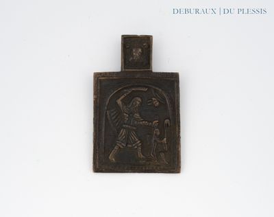 a small metal plaque with a picture of jesus on it
