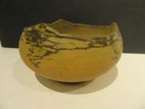 a yellow and black bowl sitting on a white table