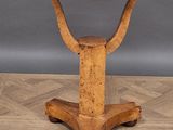 an old wooden table with a metal top on a parquet floor