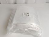 a plastic bag of food sitting on a white table