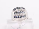 a close up of a ring with blue and white diamonds