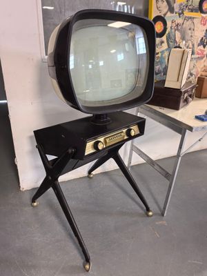 a small television sitting on a stand in a room