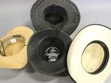 several hats are lined up on a table with a hat on top