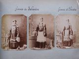 an old photo of three women dressed in traditional clothing