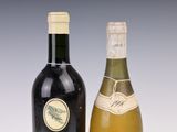 two bottles of wine sitting next to each other on a table