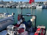 a boat that is docked at the dock with other boats