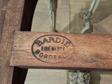 a close up of a wooden bench with a sign on it