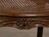 a close up of a wooden table with a woven seat