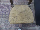 a person standing next to a chair on a rug