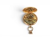 a gold pocket watch with a key hanging from it ' s side