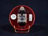 une montre posée dans un écrin rouge sur une surface noire