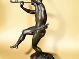 bronze statue of a man with a flute in his hand