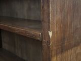 a wooden book shelf with a bunch of books on it