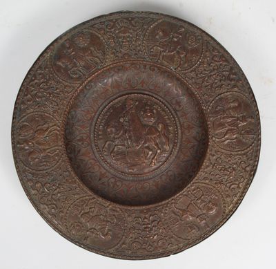 a brown plate with a design on it on a white surface