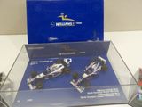a display case with two racing cars in it