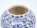 a blue and white vase with a bird design on it