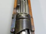 an old rifle with a wooden frame and metal handle on a white surface