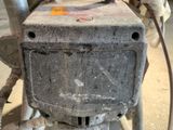 a machine that is sitting on the ground in the garage