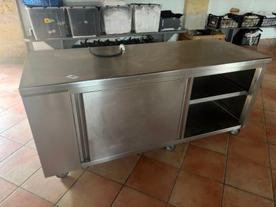 a stainless steel kitchen island with a sink and a stove