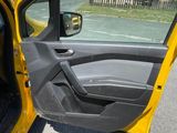 the door of a yellow car is open on the street
