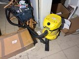 a yellow blower sitting on the floor next to a pile of boxes