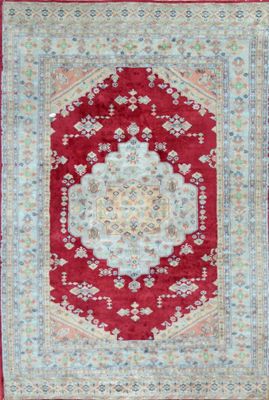 a red rug with a medallion design on it