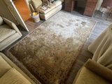 a living room with two couches and a rug on the floor