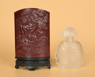 a small vase and a small glass bottle on a table