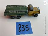 un petit camion vert avec une étiquette bleue dessus