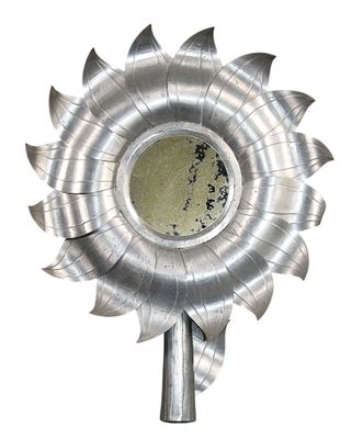 a metal sunflower shaped object on a white background