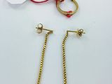 two pairs of gold earrings and a pair of gold chains