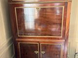 a small cabinet with a marble top in a room