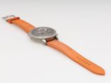 a close up of a watch on a white surface with a white background