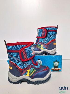 the children ' s boots are blue and red with thomas the train on them