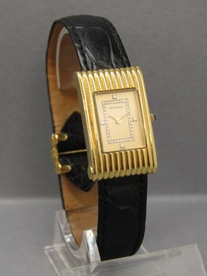 an image of a gold plated wrist watch with a black leather band