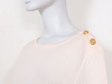 the mannequin is wearing a pink sweater with gold buttons on it