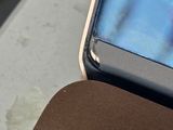 a cell phone sitting on top of a laptop computer