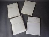 four pieces of white paper sitting on top of a table