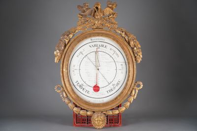 a clock that is sitting on a stand with a clock on it