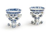 two blue and white vases sitting next to each other
