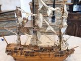 a wooden model of a ship on a table