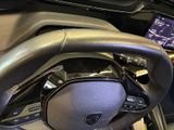 the steering wheel of a car with a digital display on the dashboard