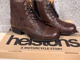 brown leather boots with brown laces are on top of a cardboard box