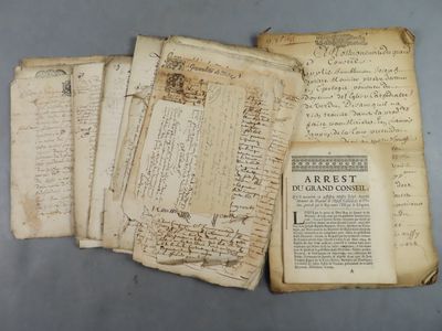 several old papers are stacked on top of each other on a table