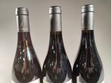 three bottles of wine that are sitting on a table